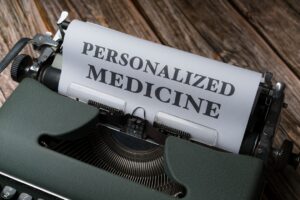 Blog 5 Vintage green typewriter with a sheet that reads 'PERSONALIZED MEDICINE' on a wooden surface.
