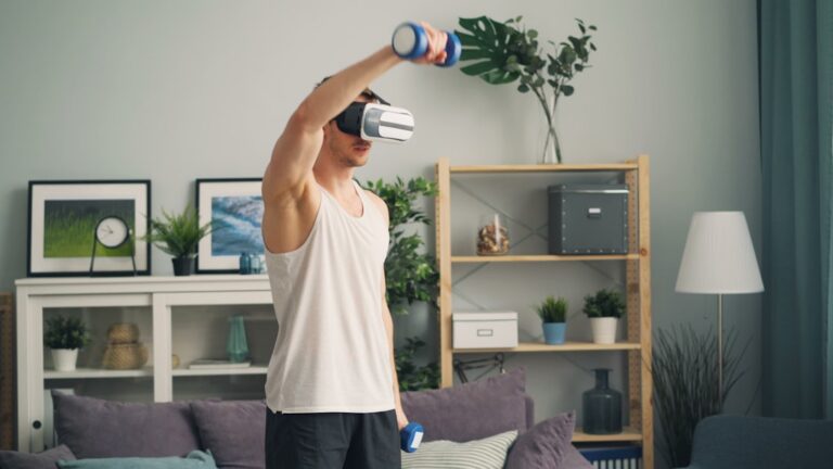 Man wearing a virtual reality headset and lifting a blue dumbbell in a living room